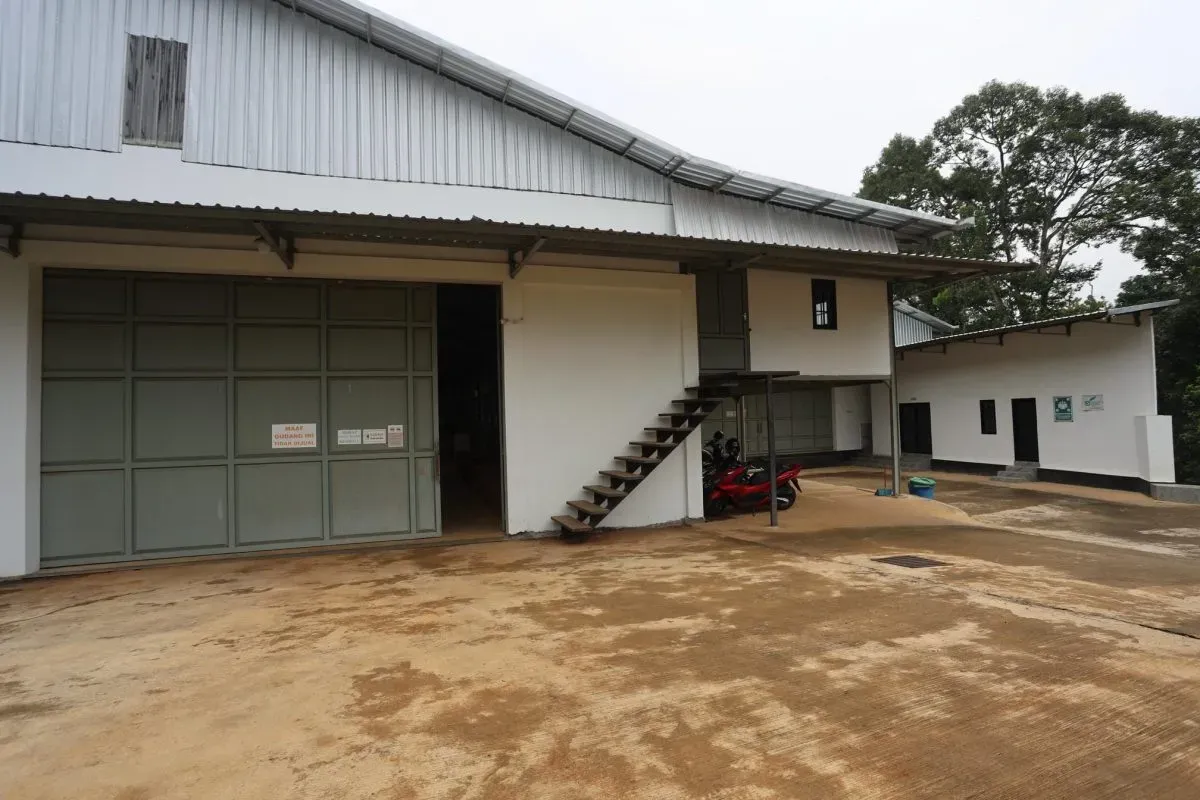 Industrial warehouse building with motorcycles outside
