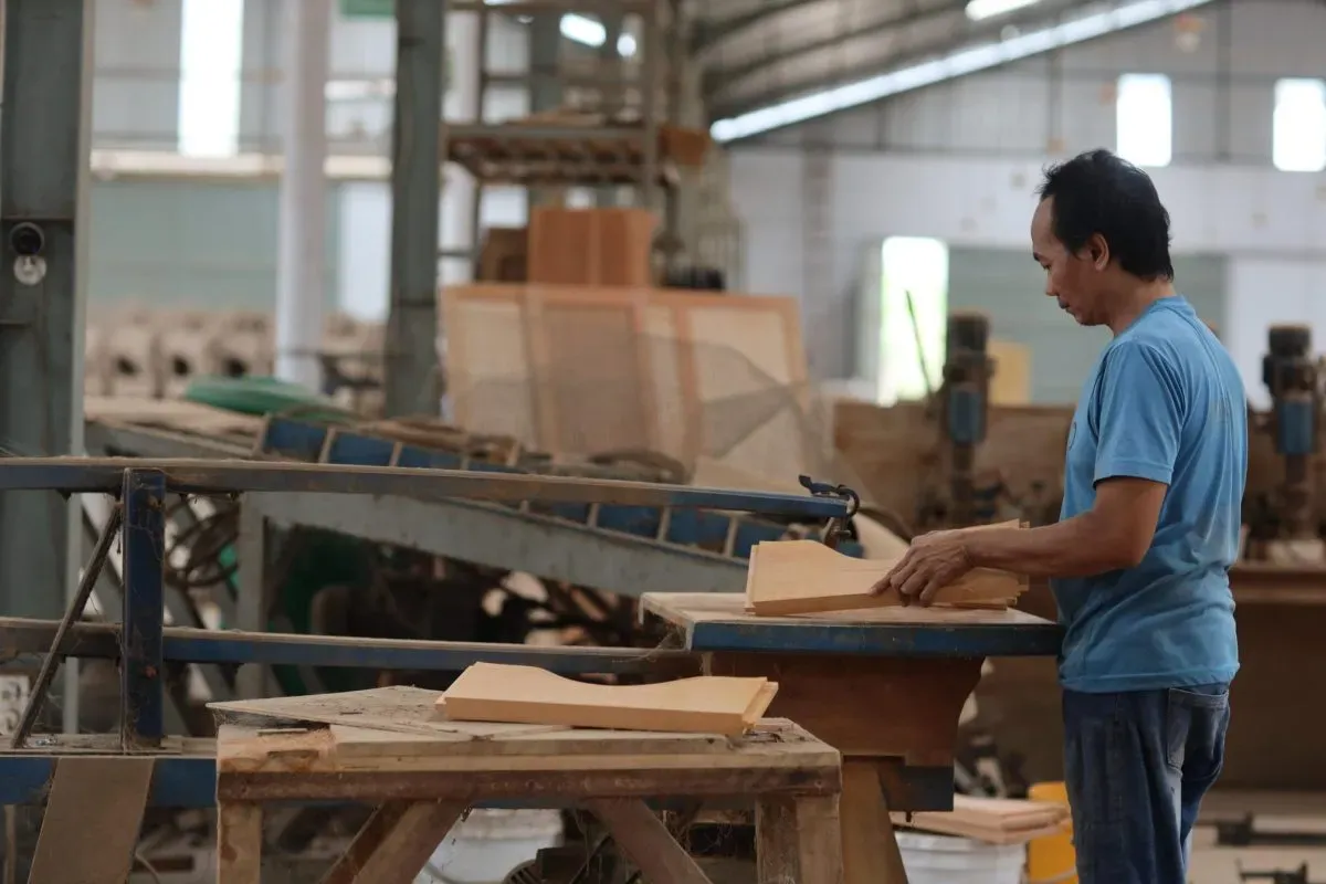 Worker crafting wood pieces in a workshop
