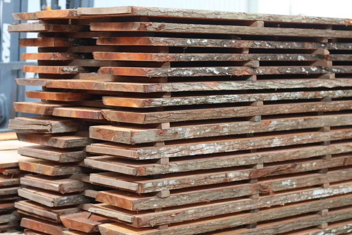 Stacked rough wooden planks ready for drying