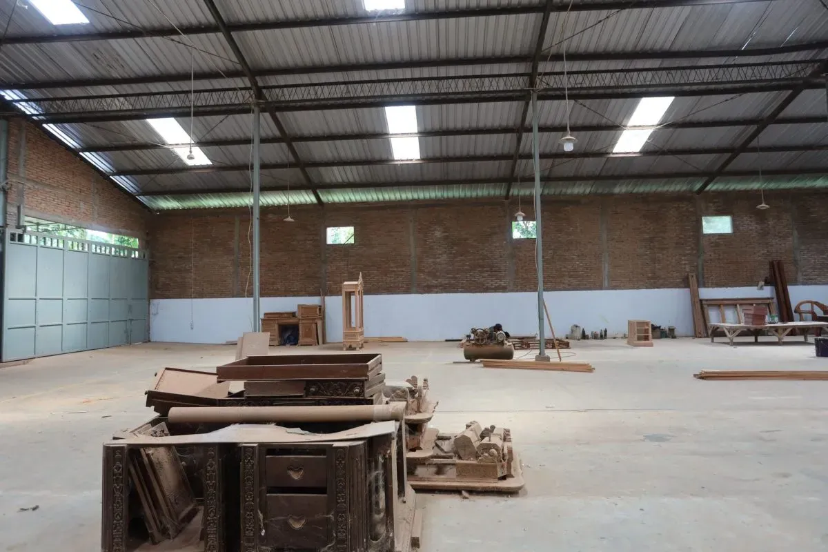 Spacious warehouse with wooden furniture and tools