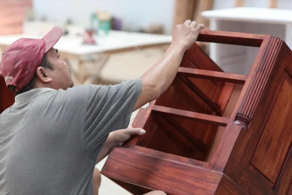 Carpenter assembling a wooden cabinet