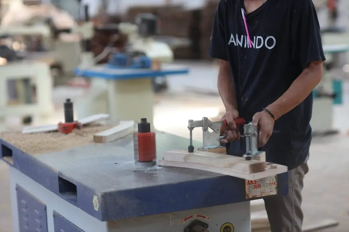 Worker shaping wood in a carpentry workshop
