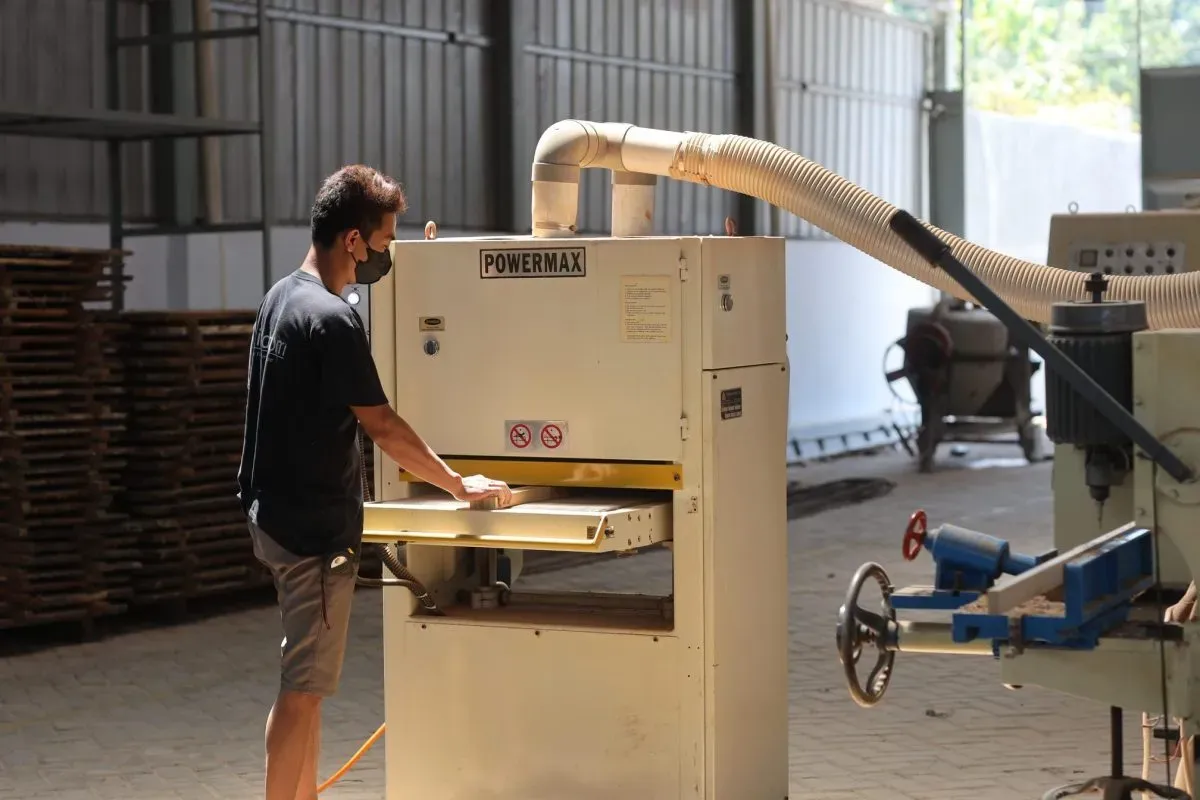 Worker operating industrial woodworking machine