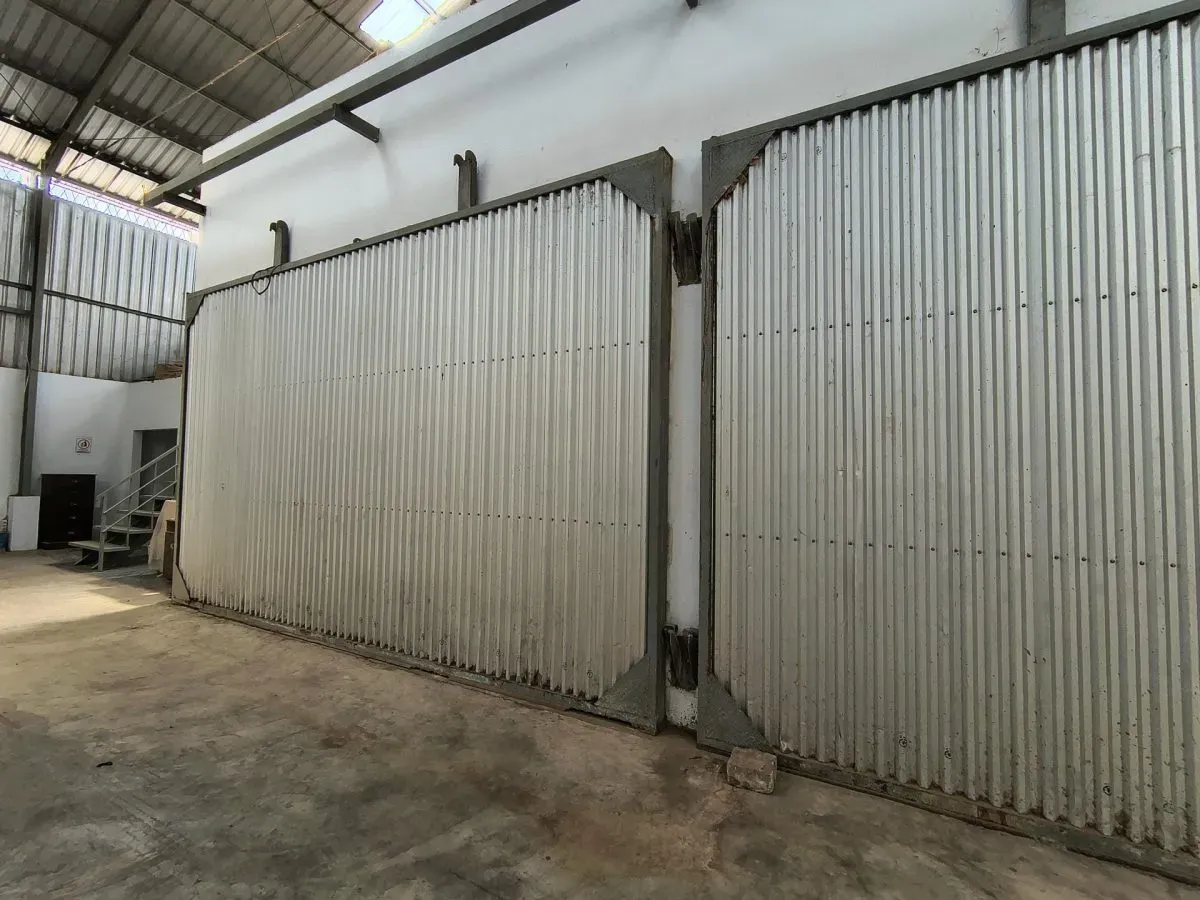 Large metal sliding doors inside industrial warehouse