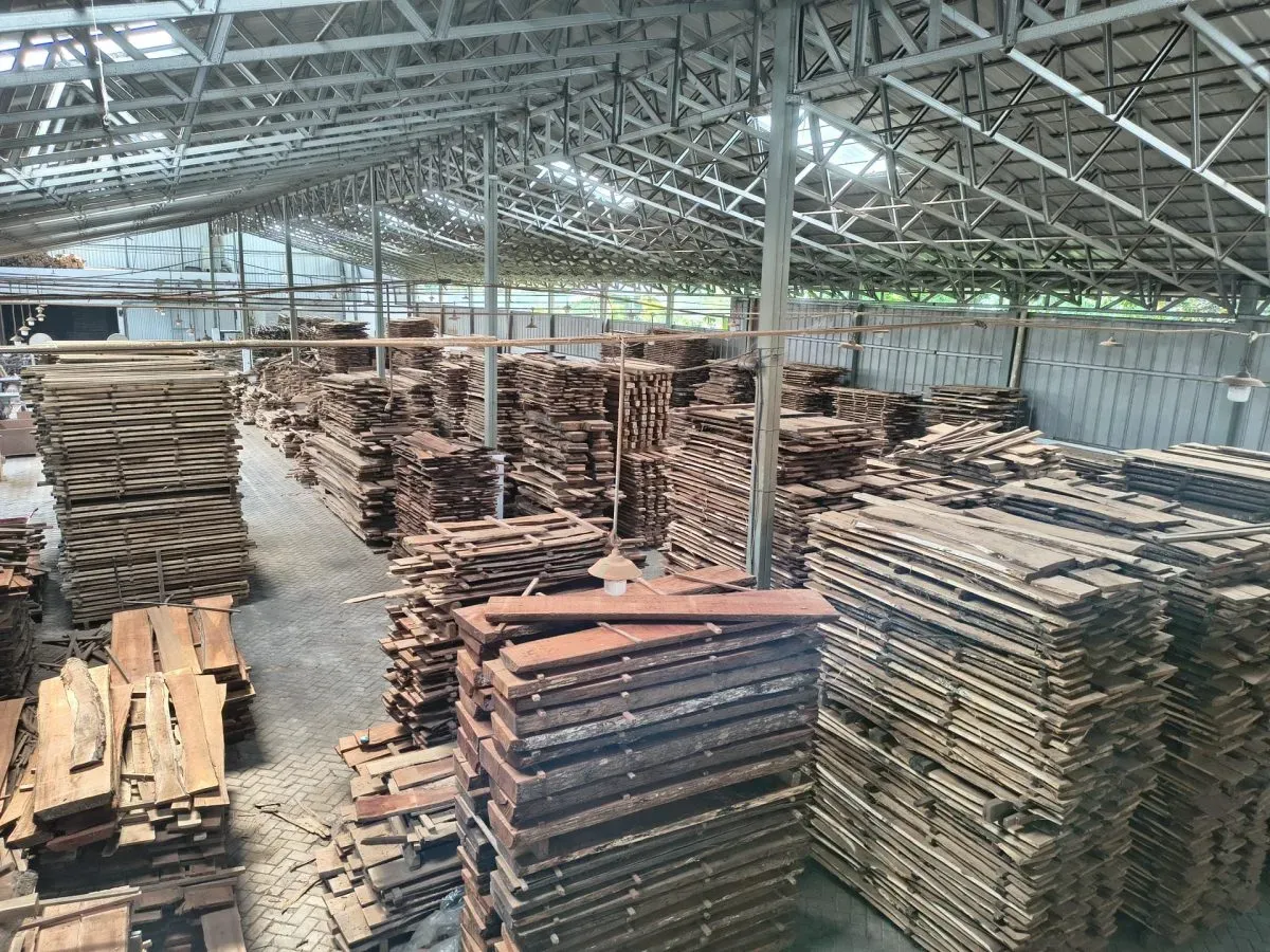 Stacks of wooden planks inside lumber warehouse