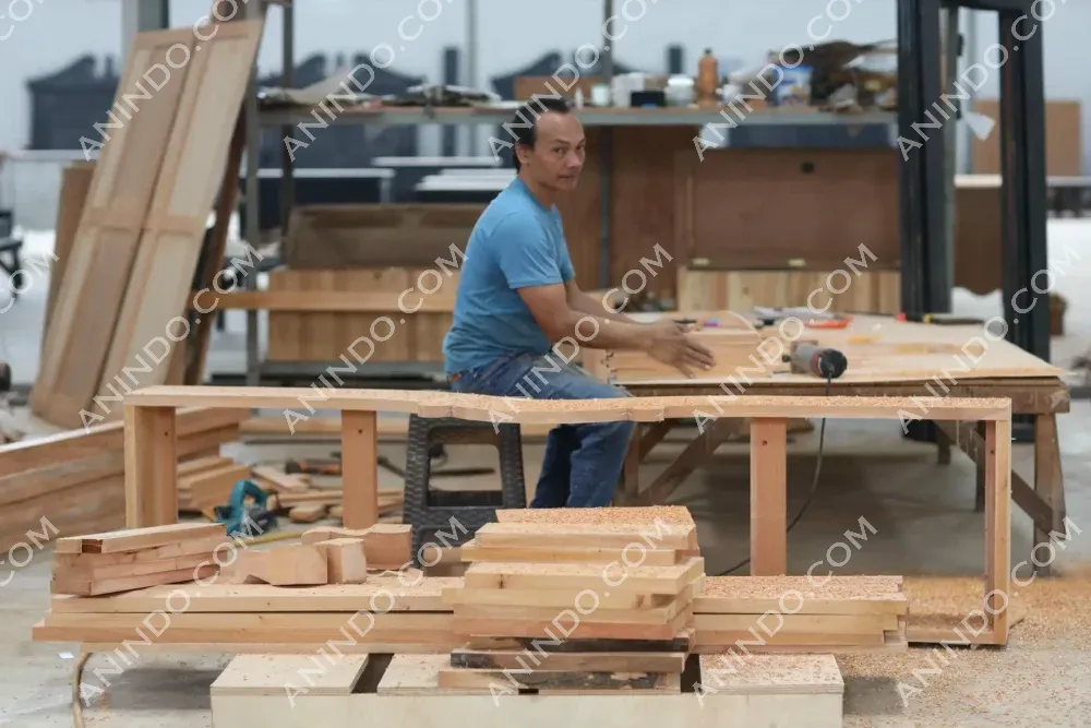 Carpenter working with wood in workshop