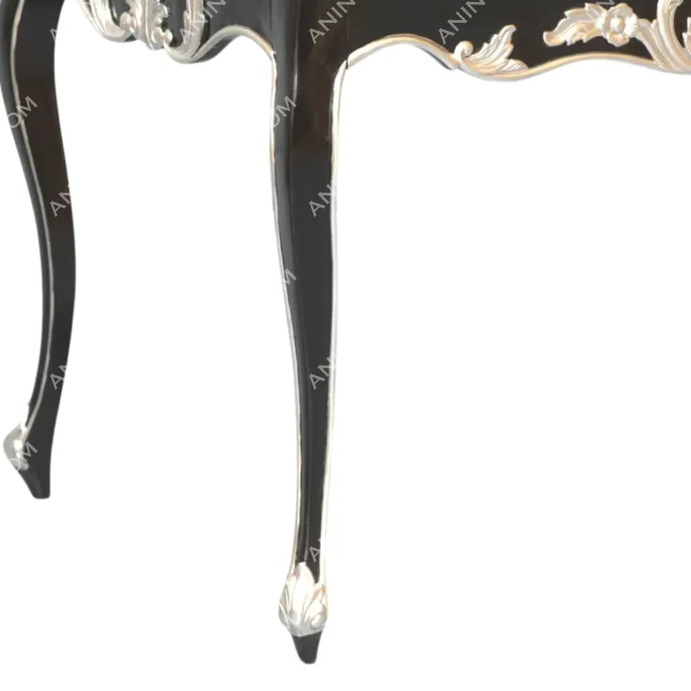 Black ornate table leg with silver floral design