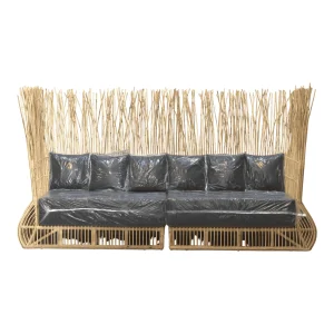 Stylish rattan sofa with dark cushions and backrest.