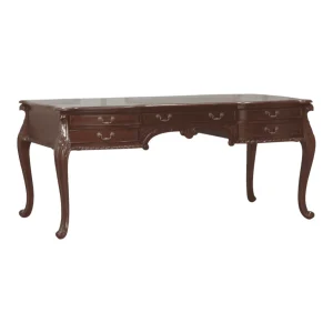Elegant wooden desk with carved legs and drawers.