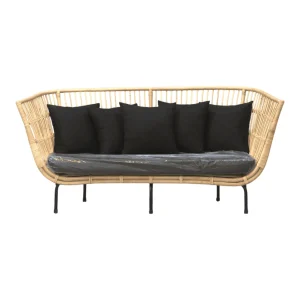 Stylish wicker loveseat with black cushions.