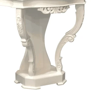 Elegant white table with ornate legs.