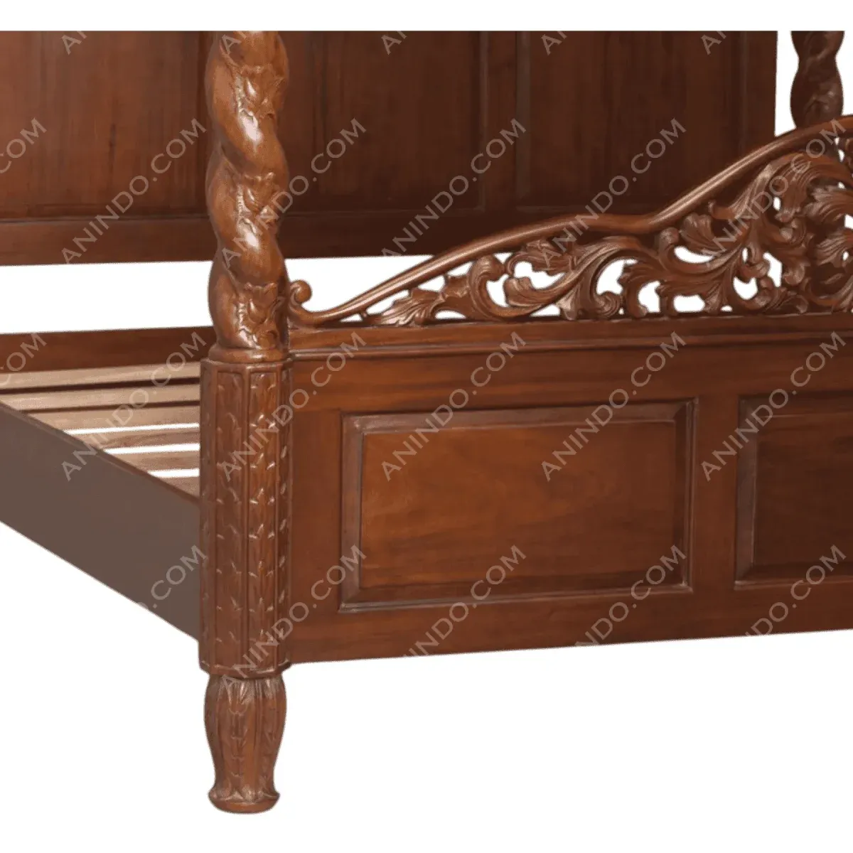 Intricately carved wooden bed with decorative details.