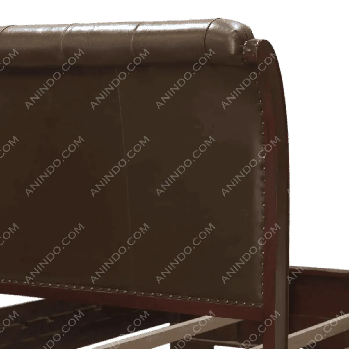 Brown upholstered bed headboard with decorative nails.