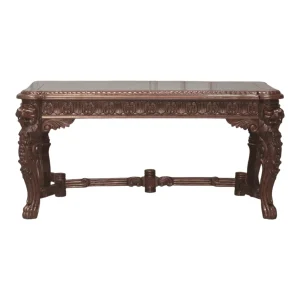Intricately carved wooden table with lion motifs.