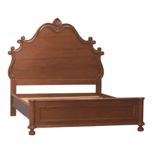 Elegant wooden bed with a decorative headboard.