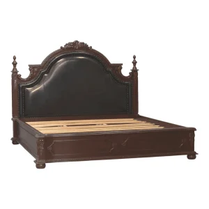 Elegant dark wood bed with ornate headboard design.