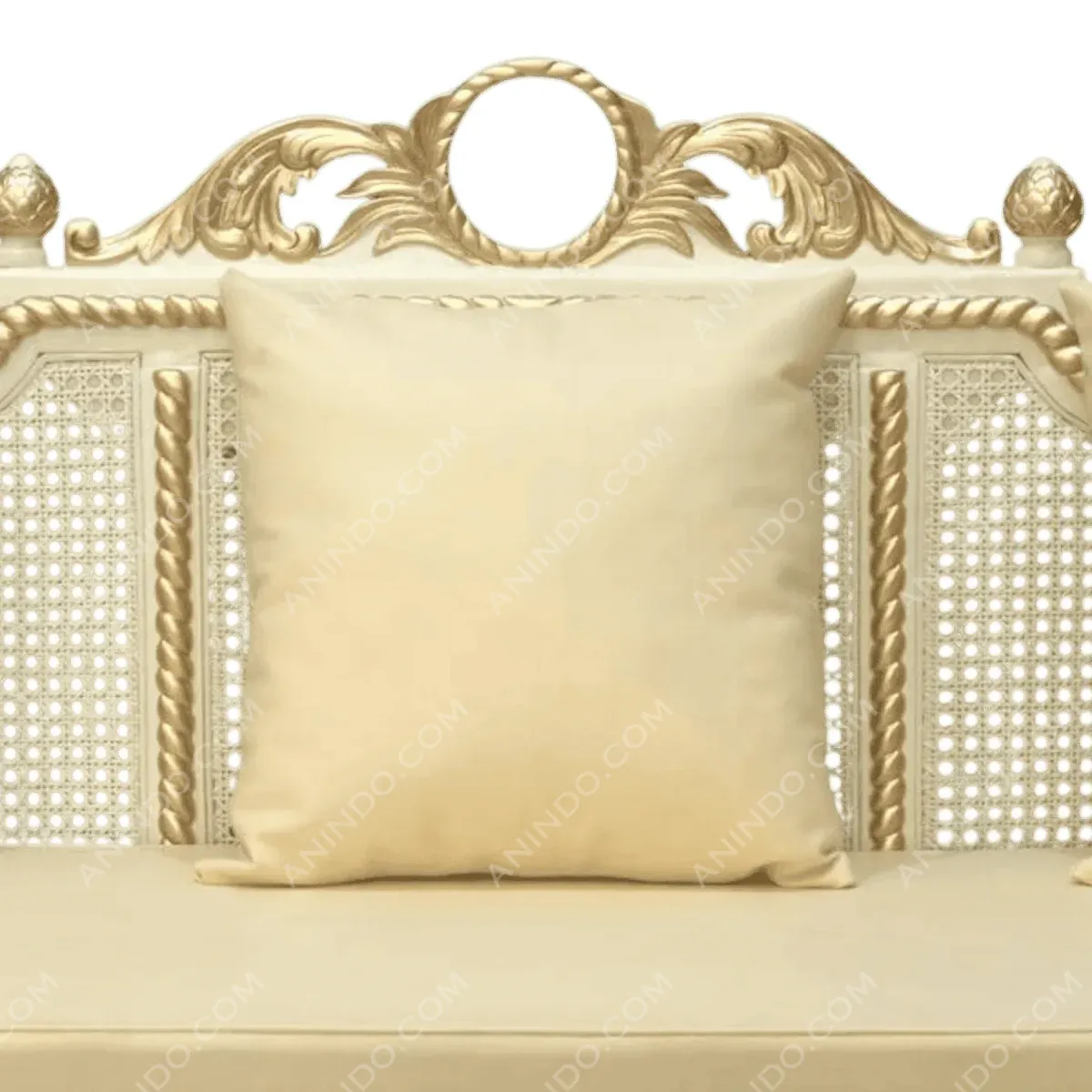 Elegant beige pillow on ornate sofa.