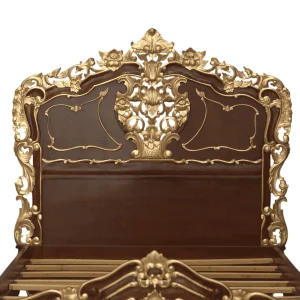 Ornate wooden bed headboard with golden embellishments.