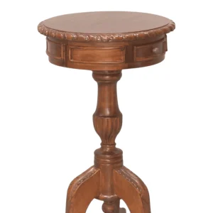 Wooden round side table with intricate detailing.