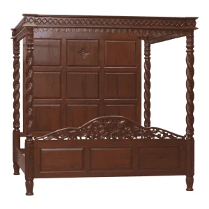 Elegant wooden canopy bed with intricate carvings.