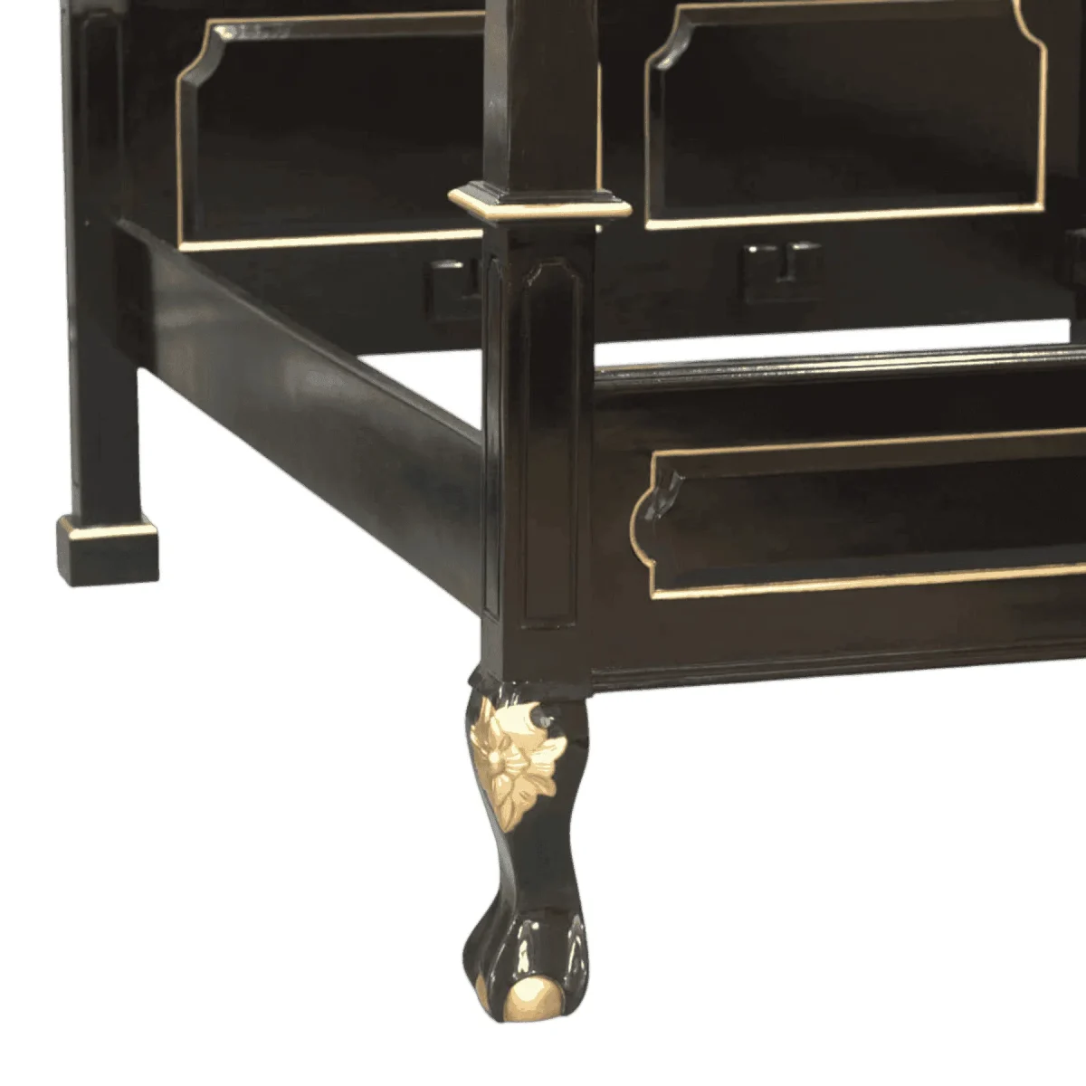 Elegant black furniture leg with gold accents.