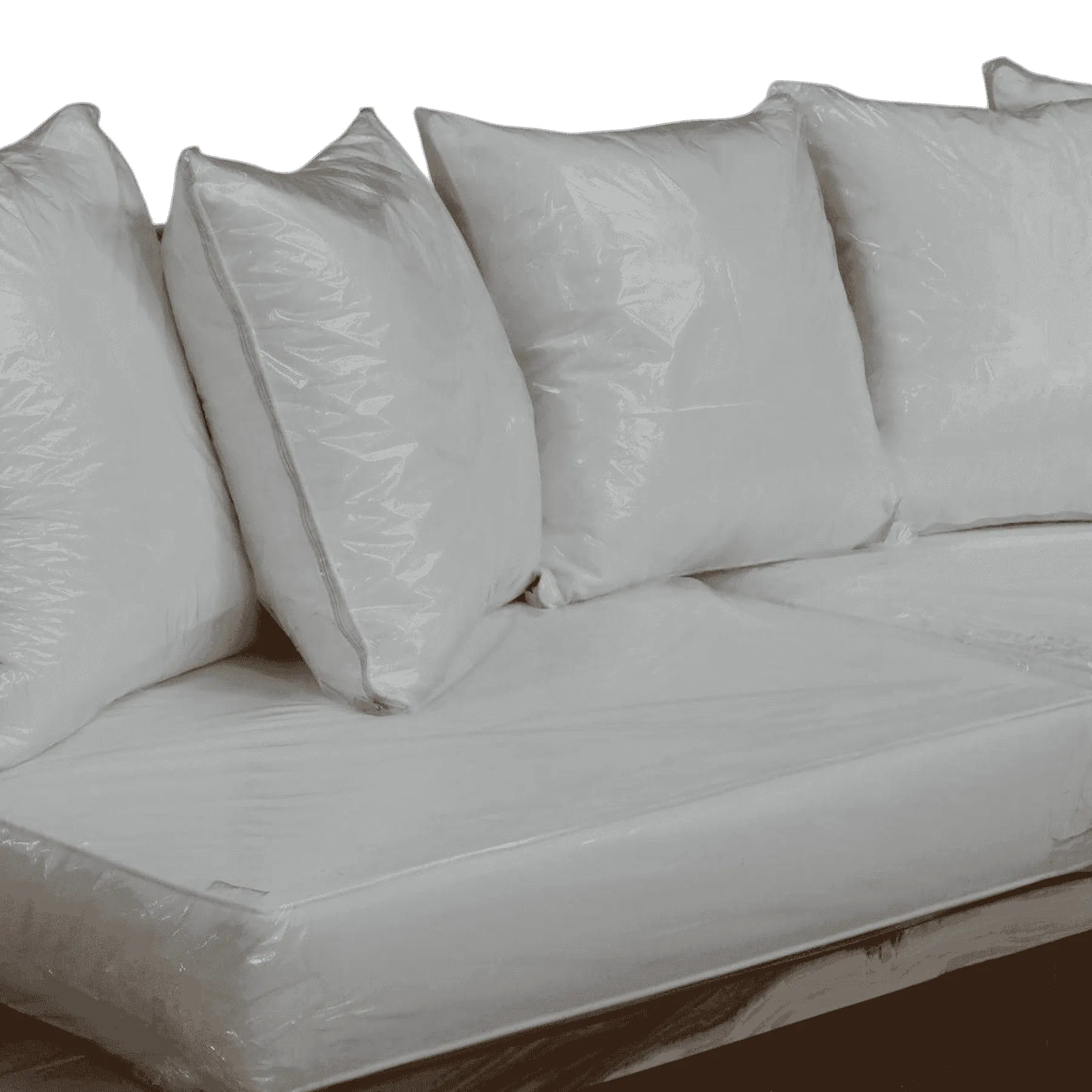 White sofa cushions wrapped in plastic covers